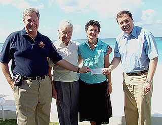 Felix Francis (right), along with Dick Francis and Mrs. Jennifer Dilbert, presents a donation to the National Recovery Fund's Executive Director, Dr. Mark Laskin (left).
