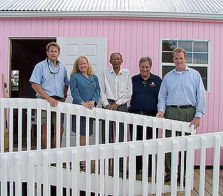 Bodden Town resident, Mr. Elwood Levy (centre), and members of the Webster Foundation (from left) Giles Charlton-Jones, Pamela Webster and Ben Webster (right).
